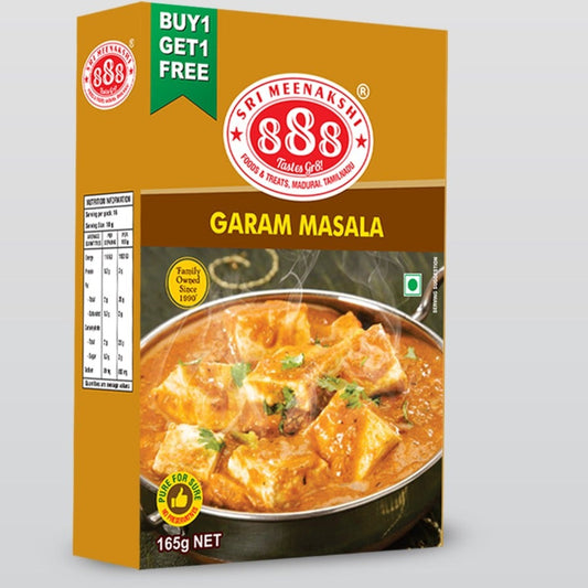 Garam_Masala_in_kraft_pouch_with_whole_spices_like_cinnamon_cloves_and_cardamom_arranged_on_traditional_Indian_spice_tray