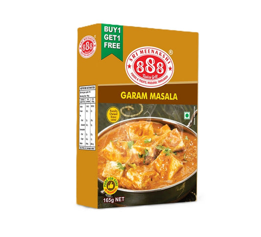 Garam_Masala_in_kraft_pouch_with_whole_spices_like_cinnamon_cloves_and_cardamom_arranged_on_traditional_Indian_spice_tray