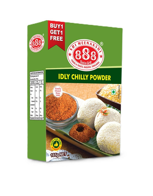 Idly Chilli Powder in pouch with soft idlis, sesame oil, and brass bowl on banana leaf background