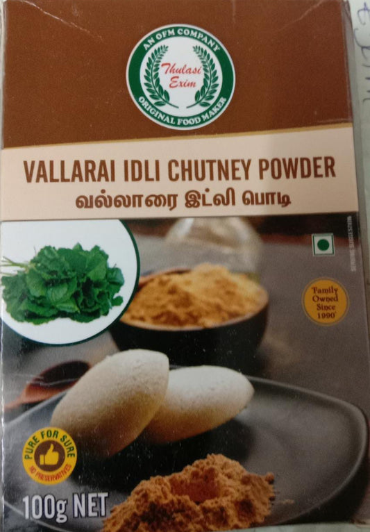 Vallarai Idly Chutney Powder pouch with soft idlis, sesame oil, and fresh vallarai (Brahmi) leaves arranged on a banana leaf background