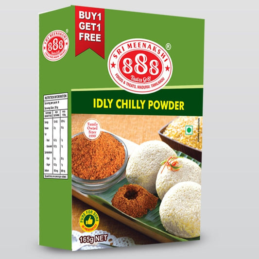 Idly Chilli Powder in pouch with soft idlis, sesame oil, and brass bowl on banana leaf background